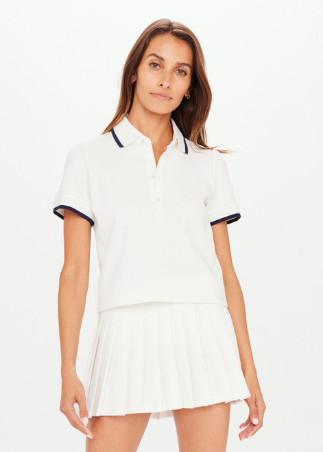 THE UPSIDE Bounce Birdie Crop Polo in White is a sustainable organic cotton cropped polo with a rib collar and sleeve cuffs with a navy edge stripe and button collar opening.