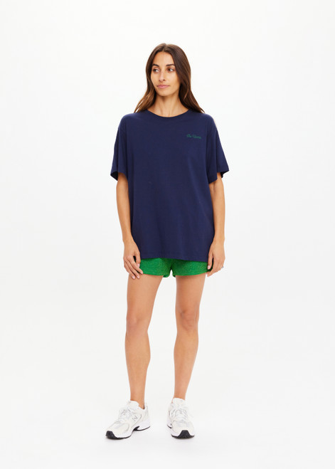 THE UPSIDE women's navy organic cotton Sammi Tee is an oversized fit and features The Upside logo on front and a printed palm tree sunset design on back. Made for lifestyle.