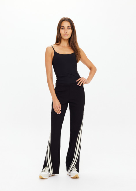 THE UPSIDE women's black Petra Flare Pant is made from soft suiting fabric and features elasticated waistband, side pockets and contrast cream stripes down side seams. Made for lifestyle.