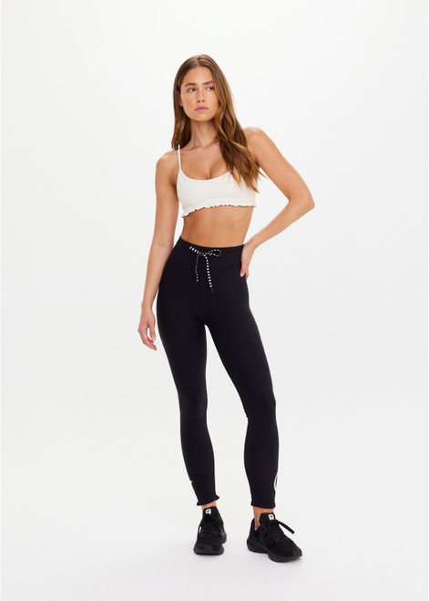 THE UPSIDE women's black recycled peached Celestia 25inch Legging is a soft & supportive fit and features a drawcord and printed star and horseshoe on ankles. Made for yoga & pilates.