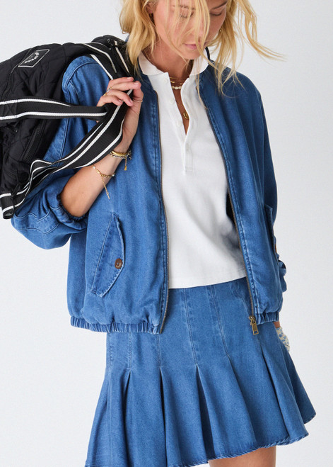 THE UPSIDE women’s blue denim Lykke Jaida Pleated Skirt, in a soft chambray fabrication, features an inner spin short with piping at the top edge. Made for tennis.