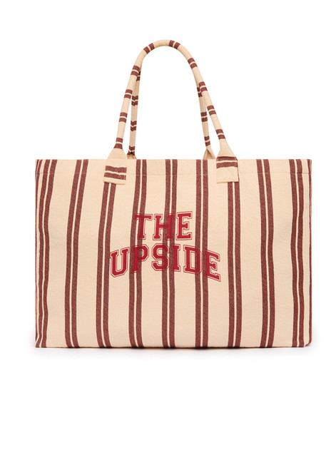 THE UPSIDE women's stripe organic cotton Baja Rhodes Tote Bag features tubular straps and a yarn-dyed cream and burnt red stripe design.