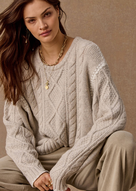 THE UPSIDE women's natural wool blend Xanthe Crew Neck Knit Sweater has a relaxed fit with cable knit and decorative blanket stitching. Made for lifestyle.