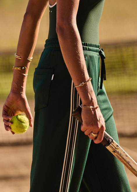 THE UPSIDE women's green Roma Pant is a highwaisted, true-to-size fit made in double-faced jersey and features contrast tape down side seams, side pockets and an elasticated waistband with drawcord.