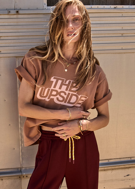 THE UPSIDE women’s brown 100% organic cotton Jacob Tee is designed for an oversized fit and features a ribbed collar and printed logo detail. Made for lifestyle.