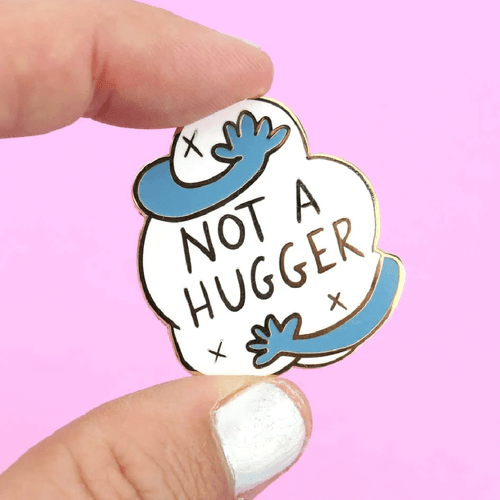 For those who value personal space and prefer a friendly wave to a warm embrace, the Jubly-Umph - Not A Hugger Lapel Pin is your perfect accessory!