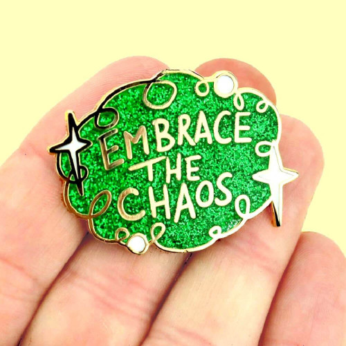 Wear your Jubly-Umph - Embrace The Chaos Lapel Pin to prove you've learned to embrace the chaos, to dance in the storm, and find joy in the unpredictability of life.