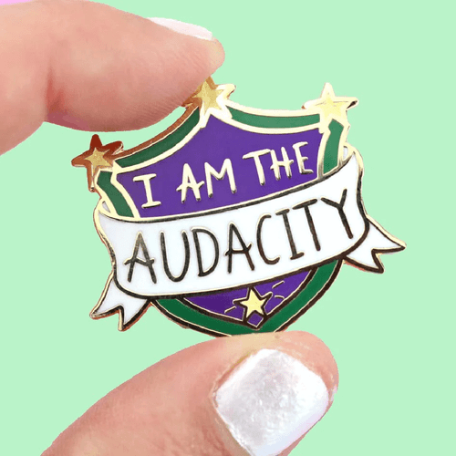 The Jubly-Umph - I Am The Audacity Lapel Pin is more than just a fashion statement; it's a declaration of self-confidence, individuality, and the sheer joy of being unapologetically you.