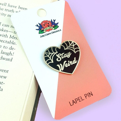 The Jubly-Umph - Stay Weird Black Lapel Pin is an ode to everyone who never let societal pressures change their quirky essence.