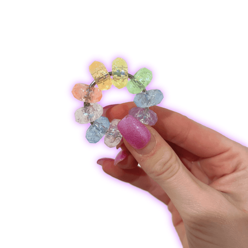 Dinky Things Fidgets - Ripple Ring is a mesmerising fidget masterpiece featuring nine shimmering beads, each boasting a diamond-cut surface that catches the light.