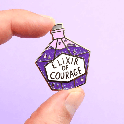 The Jubly-Umph - Elixir of Courage Lapel Pin is a wearable reminder that challenges are temporary, and you can overcome them with courage and resolve.