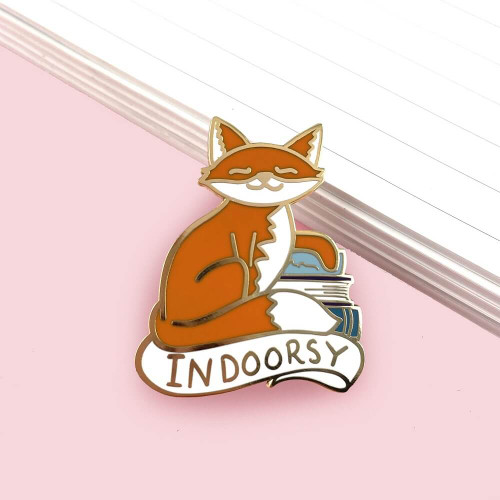 The Jubly-Umph - Indoorsy Lapel Pin celebrates the introverted, home-loving individuals who find comfort and joy in the cozy confines of the indoors.