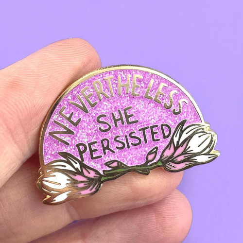 The Jubly-Umph - Nevertheless She Persisted Lapel Pin is a tribute to the strength, resilience, and determination of women who continue to make their voices heard.