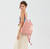 Elevate your style with our Kitty Charm Cotton Rucksack, as showcased by a chic young woman in a relaxed pastel outfit. The dusty rose rucksack, adorned with a playful kitty charm, sits comfortably on her back, highlighting its versatility and fashionable appeal. Its soft color effortlessly complements her ensemble, making it an ideal accessory for a day out or a casual event. Experience both functionality and flair with this trendy piece