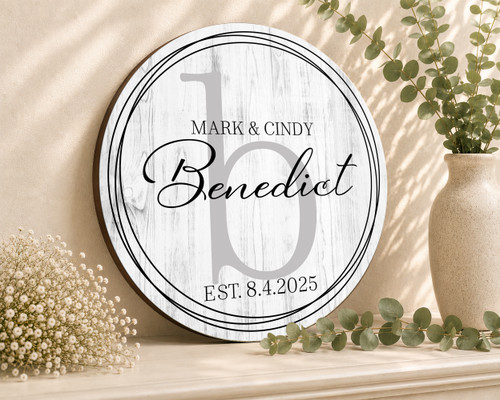 personalized wood wedding sign containing the couple's first and last names, wedding date, and background monogram in a farmhouse style white, black and gray color tone