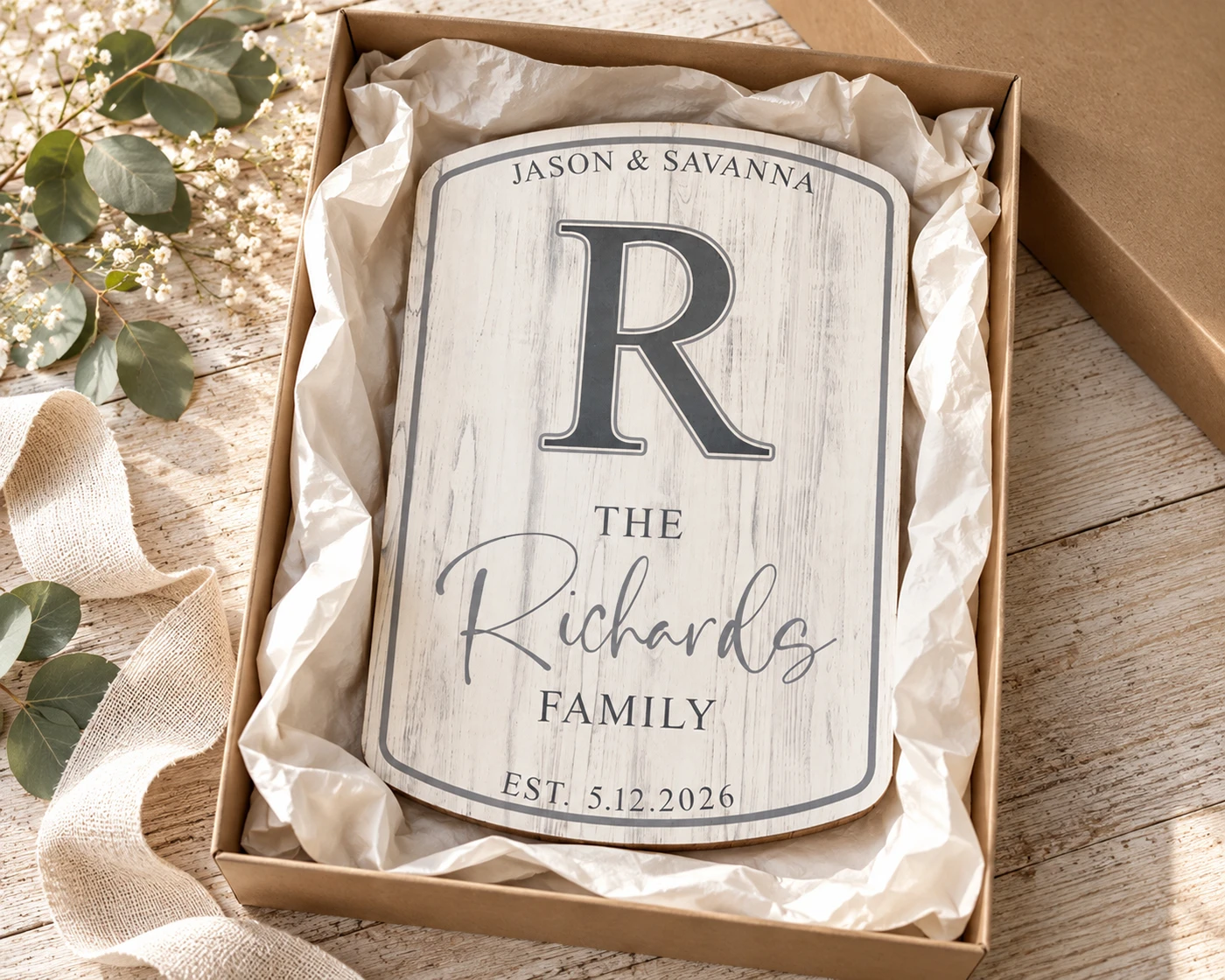 Personalized wood family sign presented in a gift box for a fifth wedding anniversary