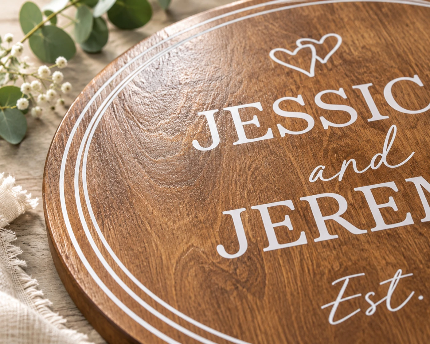 Close-up of personalized anniversary sign printed on natural wood showing visible wood grain