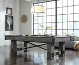 American Heritage Billiards American Heritage Fresco Pool Table in Marble, in a modern living room with large industrial windows and wooden flooring.