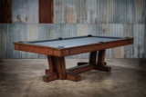 Elegant transitional contemporary pool table, the Doc & Holliday Caroline Slate Pool Table, showcasing its sleek frame and classic design. The image highlights the table's sophisticated wood finish and premium felt, set against a tastefully decorated game room that exemplifies luxury and style.