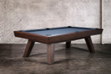 Doc & Holliday George Pool Table & Shuffleboard Combo - Antique Coffee, a stylish multi-game table with a dark wooden finish and a blue playing surface, set against a rustic brick wall.