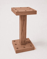 Plank & Hide Co Isaac Billiard Floor Cue Rack, wooden billiard cue stand with two square bases and a vertical support for holding billiard cues.