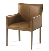Plank & Hide Co Benjamin Game Chair Burnished Oak, stylish armchair with leather upholstery and wooden legs.