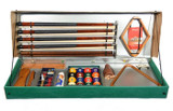 Aramith Premium Billiard Accessory Kit, a comprehensive pool table accessory set including cues, chalk, billiard balls, and repair tools in a green storage box with a transparent lid.