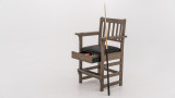 Plank & Hide Co Spectator Chair, wooden chair with armrests and a black cushioned seat, featuring a built-in pocket for buying accessories and a slot for loads, with a pool cue leaning against the chair.