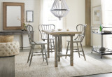 Hooker Furniture Exton Stationary Sofa, rustic wooden dining table with four paintedwood chairs in a cozy, farmhouse-style dining room with natural light and neutral decor.