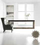 Hooker Furniture Melange Vienna Console, modern minimalist office space with a sleek console table, a leather armchair, and decorative artwork and sculpture.