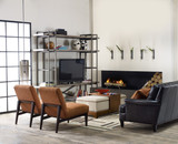 Hooker Furniture Studio 7H Scaffold Entertainment Console, modern living room with black leather sofa, brown chairs, and a large metal and wood entertainment unit with TV, decorative vases, books, and a fire feature.