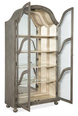 Hooker Furniture Alfresco Costa Display Cabinet, distressed wood finish with glass doors and shelves, decorative curved wooden accents, and traditional style craftsmanship.