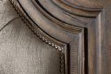 Hooker Furniture Fair Oaks King Upholstered Bed, close-up of the wooden headboard's detailed craftsmanship and nailhead trim.