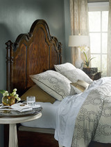 Hooker Furniture Leesburg Queen Poster Bed, a luxurious wooden bed with an intricate carved headboard in dark finish, set in a well-lit bedroom with elegant bedding, gold accent pillows, and classic decor.