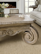Hooker Furniture Castella Square Cocktail Table, rustic wooden table with ornate carved details and a large spiral scroll design on the corner.