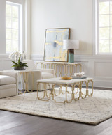 Hooker Furniture Evermore Rectangle Cocktail Table, elegant white marble top with gold geometric metal base in a modern living room.