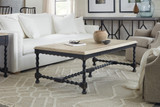 Hooker Furniture Ciao Bella Cocktail Table, a rustic wooden coffee table with black distressed finish and turned legs in a living room setting.