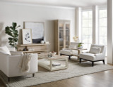 Hooker Furniture Cascade Rectangle Cocktail Table, modern living room with light wood finish coffee table in a spacious, bright area with white armchairs and decorative accents.