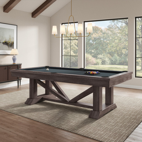 Plank & Hide Co Plank & Hide Lucas Pool Table - Nutmeg, a wooden pool table with a dark nutmeg finish, situated in a well-lit room with large windows and modern decor.