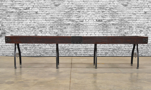 Venture Shuffleboard Williamsburg Shuffleboard Table, dining top option, made in USA, with dark wood finish and black metal legs, against a brick wall background.