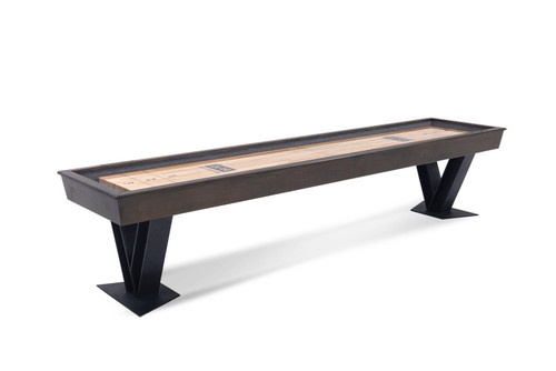 Savant shuffleboard table by Doc & Holliday in Brown Sugar finish, featuring an industrial modern cabinet, natural maple playfield, and sculptural steel V legs, shown in a clean side profile on a white background.