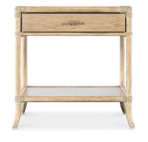 Hooker Furniture Retreat Pole Rattan Dune End Table, a light wood-colored end table with a tabletop drawer and lower shelf, featuring rattan accents on the corners and a modern design.