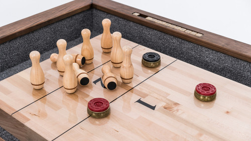 Plank & Hide Co Plank & Hide Shuffleboard Bowling Pin Set, wooden shuffleboard game with wooden bowling pins and pucks on a wooden tabletop.