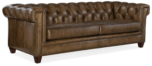 Hooker Furniture Elixir Upholstered Side Chair, a brown leather tufted sofa with rolled arms and wooden legs.