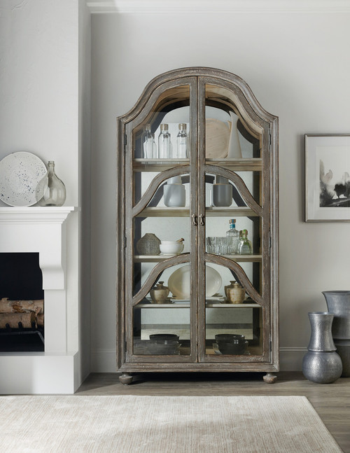 Hooker Furniture Alfresco Costa Display Cabinet, rustic wood and glass display cabinet with curved arched top and multiple shelves for storing and showcasing decorative items and dishware.