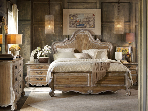 Hooker Furniture Chatelet King Wood Panel Bed, elegant bedroom with vintage rustic wooden bed featuring intricate carvings and a high, curved headboard.