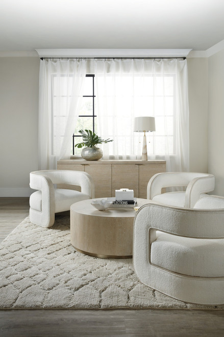 Hooker Furniture Cascade Cocktail Table, modern round beige wood coffee table in living room with white armchairs and neutral decor.