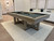 Brunswick Billiards Brunswick Matanza Slate Pool Table - Sandwash Finish, in a modern indoor game room setting with a neutral decor and artwork on the wall.