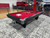 Brunswick Billiards Brunswick Black Wolf Slate Pool Table, modern black and red pool table with cues and accessories on top in an indoor showroom.