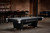 Brunswick Billiards Brunswick Black Wolf Pro Slate Pool Table in Matte Black, in a stylish game room with brick walls and bar area.